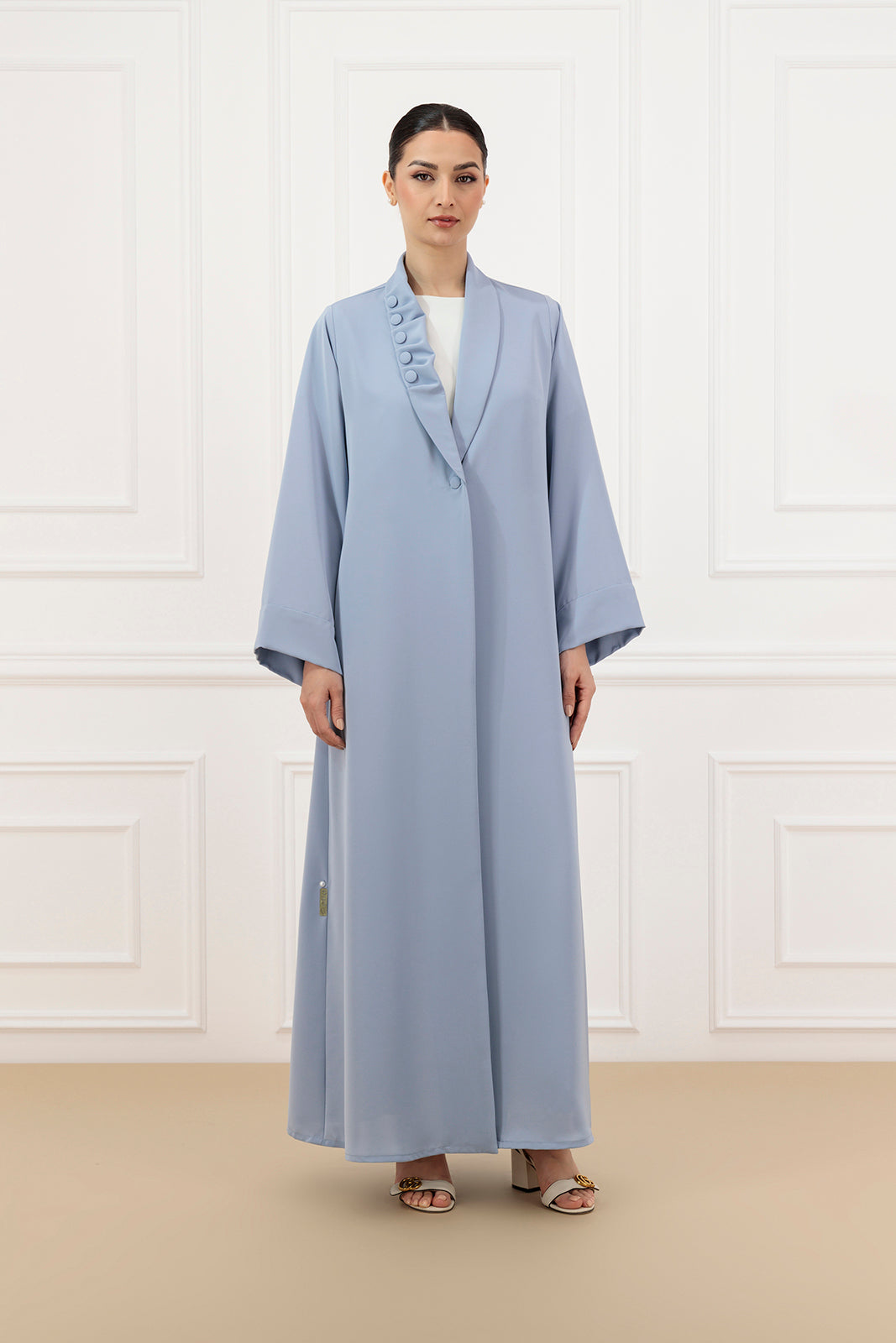 Asymmetrical pleated shawl collar with cover buttons