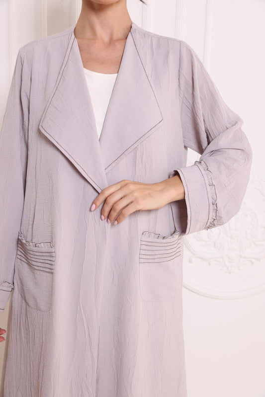 Pleated patch pockets Abaya with ruffle detailed cuffs.