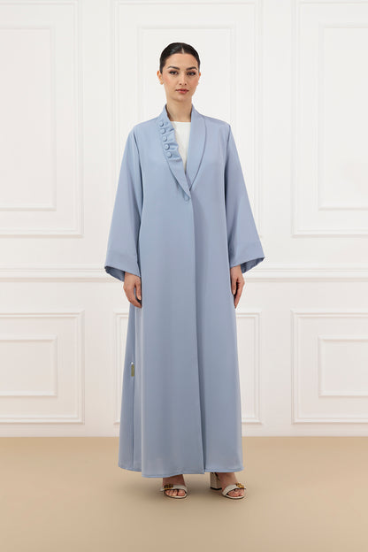 Asymmetrical pleated shawl collar with cover buttons