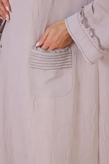 Pleated patch pockets Abaya with ruffle detailed cuffs.